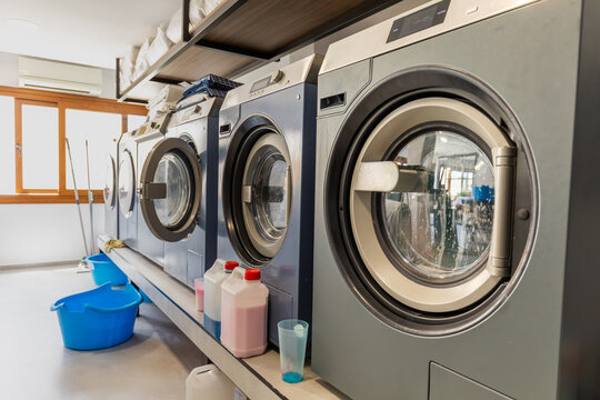 Modern laundromat interior with washing machines and supplies