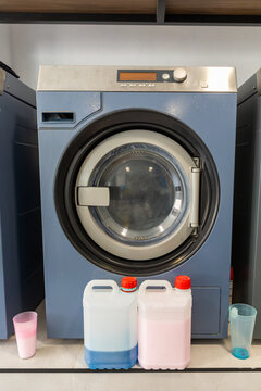 Industrial front loading washer with detergent containers