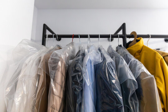 Garments on hangers in plastic covers for laundry service
