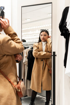 Woman shopping in urban clothing store