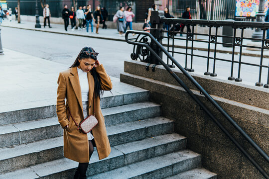 Woman stepping down urban stairs in the city
