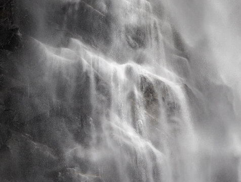 Misty waterfall detail on West Coast basalt cliff face