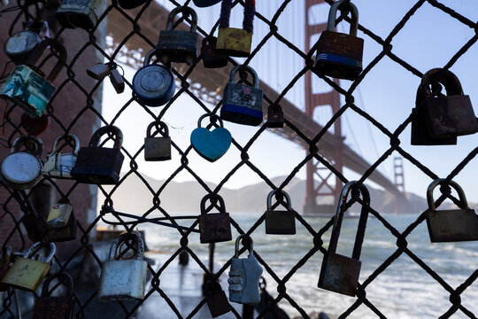 Love locks on fence with Golden Gate Bridge, West Coast
