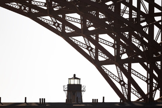 Steel Bridge lattice framing a West Coast lighthouse