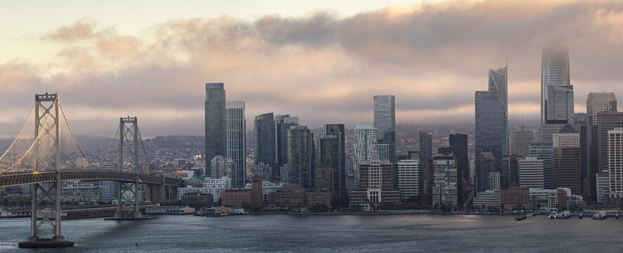 San Francisco skyline and Bay Bridge at foggy sunrise