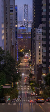 San Francisco street at dusk with Bay Bridge in view
