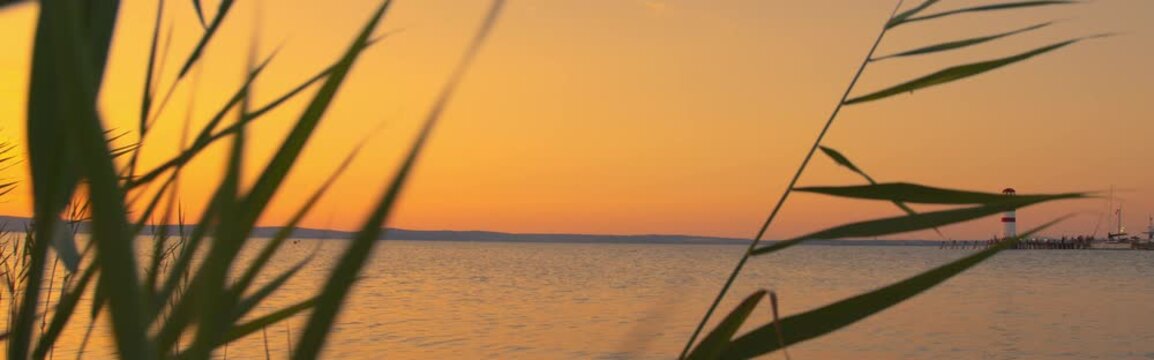 Static wide of Lake Neusiedl sunset horizon, banner space