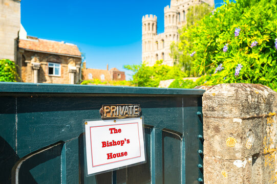Shallow focus of a Private sign attached to a garden gate in the historic cathedral city of Ely, Cambridgeshire, UK. An ad hoc Bishops sign is attached to the door, denoting the bishop of Ely lived he