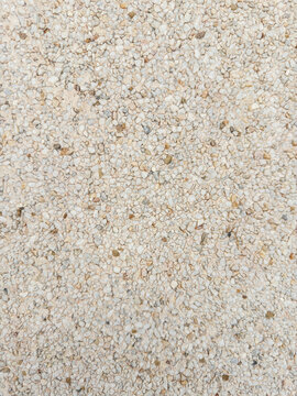 Light beige crushed stone gravel texture background