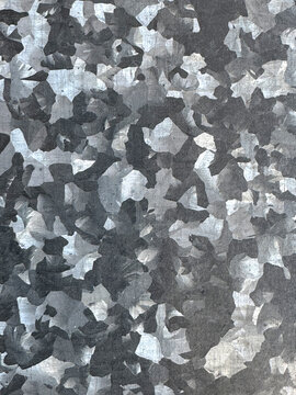 Abstract gray camouflage texture with layered paint fragments