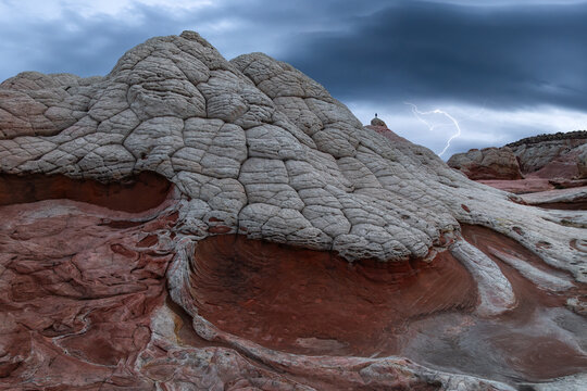 White Pocket sandstone formations under storm clouds and lightning