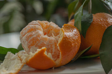 Juicy mandarin orange with fresh foliage showcasing natural freshness and bright citrus colour. Ideal for nutrition, clean eating, fruit advertising and healthy food promotion. © Anna Zaro