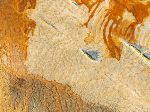 Vibrant aerial view of cracked earth mineral textures