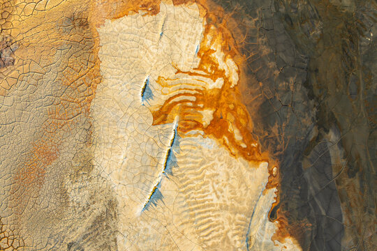 Aerial view of colorful mineral textures with cracks
