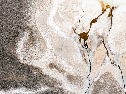 Aerial view of cracked colorful earth patterns