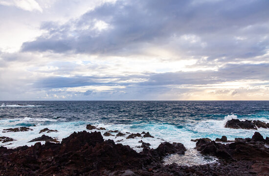 Dramatic coastal landscape at Ponta da Ferraria on Sao Miguel Island, Azores, Portugal, featuring volcanic shoreline, Atlantic Ocean and evening clouds