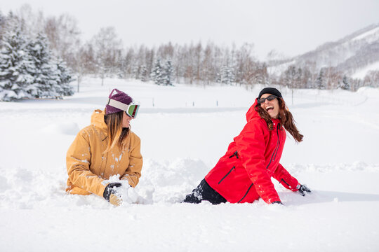 Friends enjoying snow at a ski resort