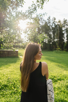 Woman practicing mindfulness during sunset outdoors