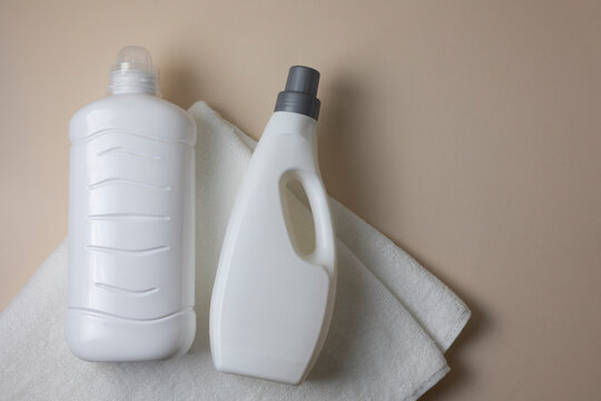 Laundry detergent bottles on color background, household cleaning concept