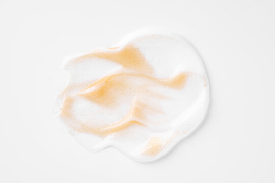 Gold cosmetic smear texture on white background