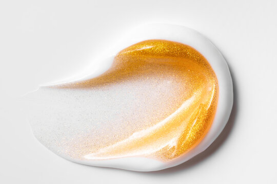 Gold cosmetic smear with shimmering luxury texture