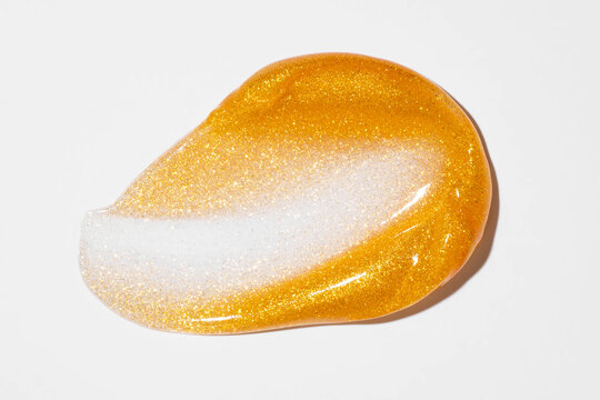 Gold cosmetic smear with pearlescent shimmer texture