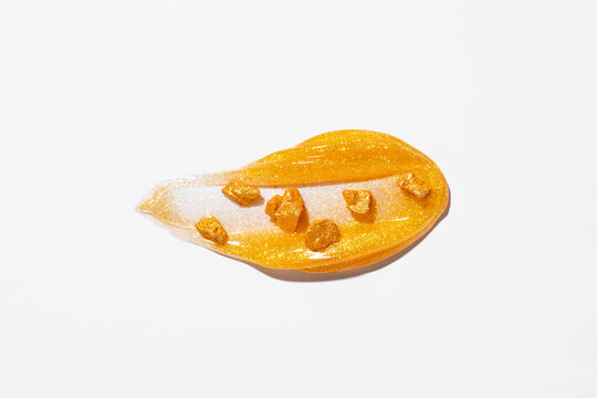 Gold cosmetic smear with glitter and mineral fragments