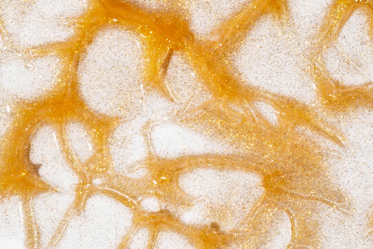 Gold cosmetic smear texture on white background