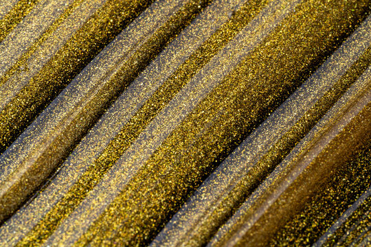 Gold cosmetic oil texture with shimmering diagonal waves