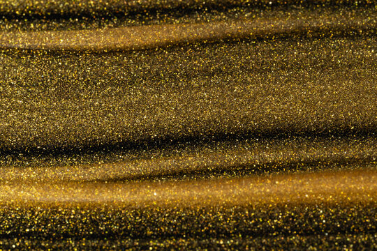 Gold oil texture with shimmering cosmetic fluid background