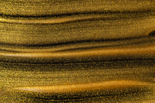 Shimmering gold oil texture for luxury cosmetic background