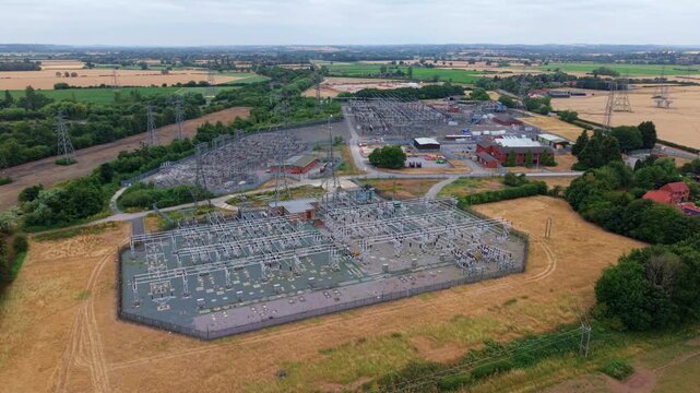 Panning aerial view of major 400kV electricity distribution substation and grid infrastructure near Newark