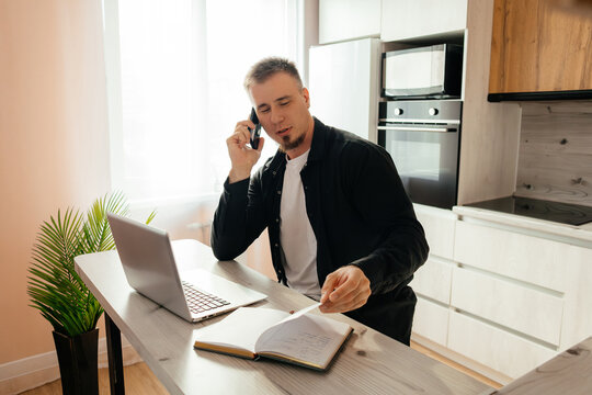 Man working remotely with laptop and phone
