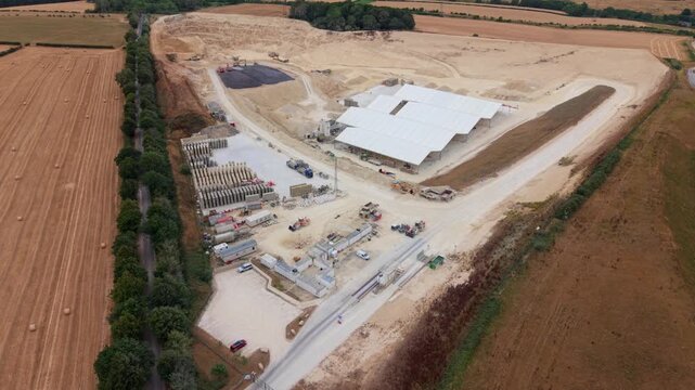 Aerial view of large open pit limestone quarry and industrial mining infrastructure near Grantham UK