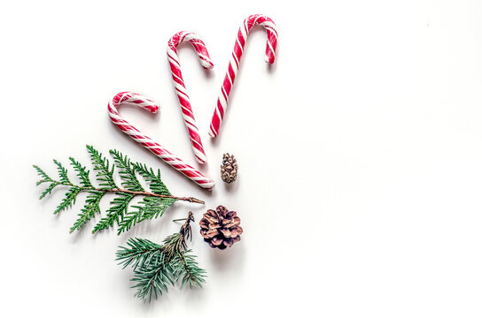 Candy cane and evergreen with pine cone holiday flat lay