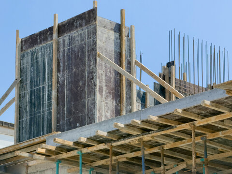 Concrete building construction with formwork and exposed rebar