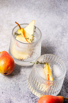 Pear elderflower spritz cocktail with thyme and ice