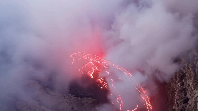 Erta Ale volcano, View of the glowing lava lake inside the crater, with molten rock patterns and dark volcanic rock walls in Zone 2, Afar, Ethiopia.