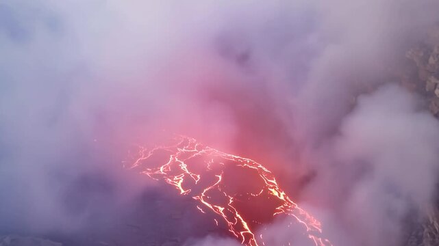 Erta Ale volcano, View of the glowing lava lake inside the crater, with molten rock patterns and dark volcanic rock walls in Zone 2, Afar, Ethiopia.