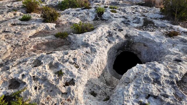 Xemxija, Malta 29.07.2026 - Xemxija Heritage trail, Neolithic tombs dug into the coralline limestone.
