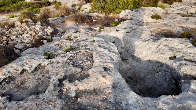 Xemxija, Malta 29.07.2026 - Xemxija Heritage trail, Neolithic tombs dug into the coralline limestone.