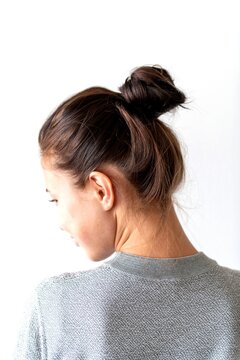 Woman's elegant messy bun hairstyle.