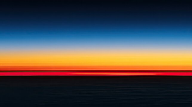Horizon ablaze with fiery reds and oranges fades to deep blue