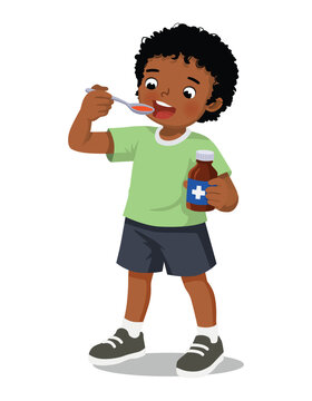 Sick African boy taking medicine syrup from a spoon
