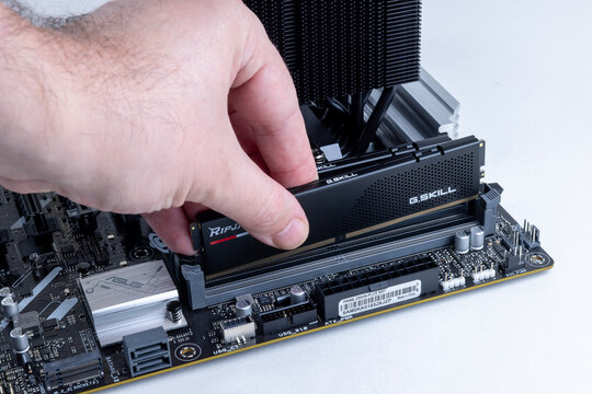 Technician installs G.SKILL Ripjaws memory modules into an ASUS Z890M-PLUS WIFI motherboard. High-end PC assembly or upgrade. Pavlodar, Kazakhstan - May 31, 2026