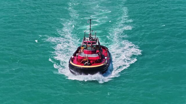 Tugboat sailing at sea top view. Motor boat. Boating and tugging. Tugboat sea transportation. Boat tug at sea. Aerial footage of tow boat transportation. 4k footage