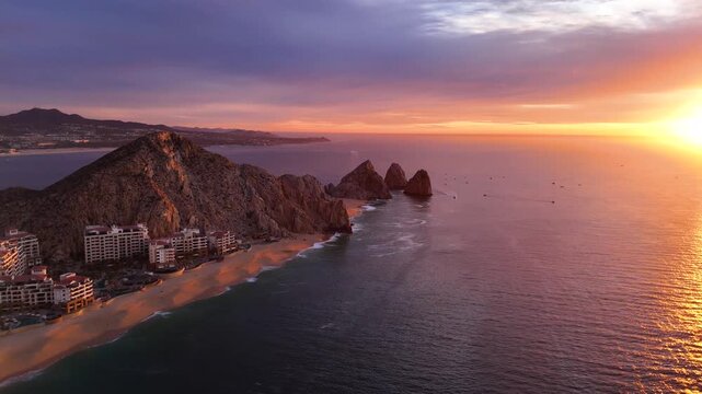 Wide drone aerial shot of rock formations and El Arco in Cabo San Lucas at sunrise in Mexico