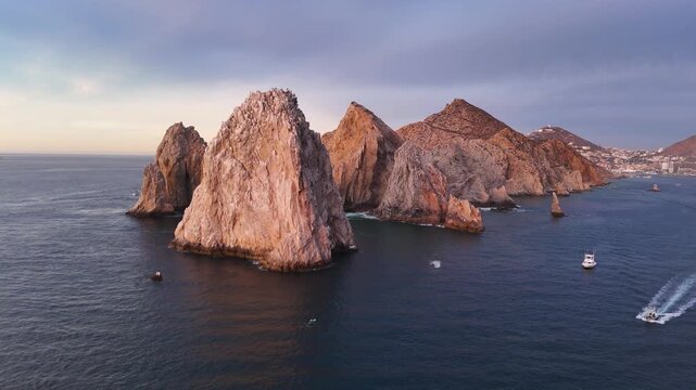 Aerial panorama of The Arch of Cabo San Lucas bathed in warm sunrise light in Mexico