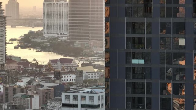 sunset time golden hour bangkok city modern building front riverside temple aerial panorama 4k thailand 