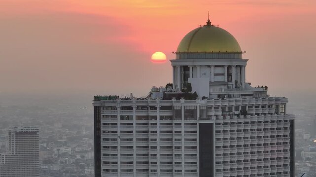 sunset time bangkok city center famous hotel top rooftop crowded bar aerial panorama 4k thailand 